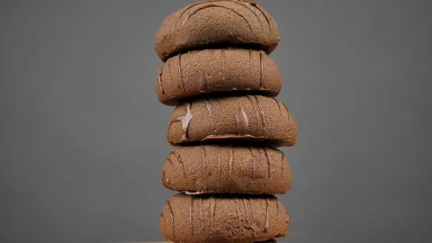 A stack of chocolate chip cookies sprouts on a gray background Stock Footage 241924382