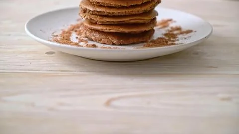 Stack of chocolate chip cookies on a white plate on wooden table 스톡 사진