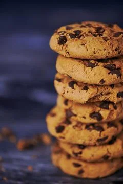 Stack of chocolate chips cookies against wooden background Stock Photos