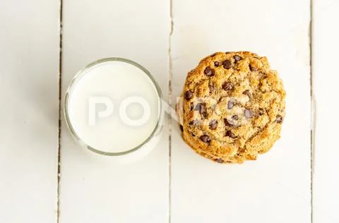 Stack of chocolate chips cookies with milk. Top view, close up. Stock Photos