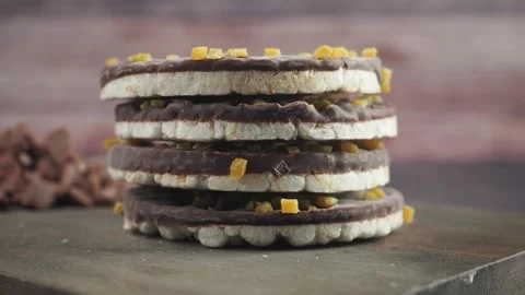 Stack of Chocolate Covered Rice Cakes Topped with Candied Fruit Stock Footage 337058565