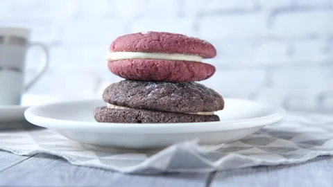 Stack of chocolate cream cookies and tea on wooden background Stock Footage 151030758