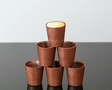 Stack of chocolate cups with liqueur Stock Photos