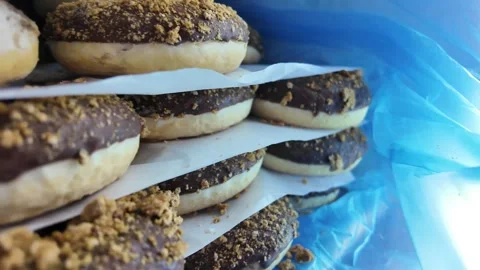 Stack of chocolate donuts in a fridge Stock Footage 315145325