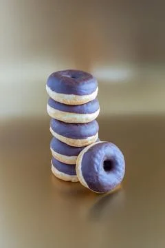 A stack of chocolate donuts on a golden background, with copy space 写真素材