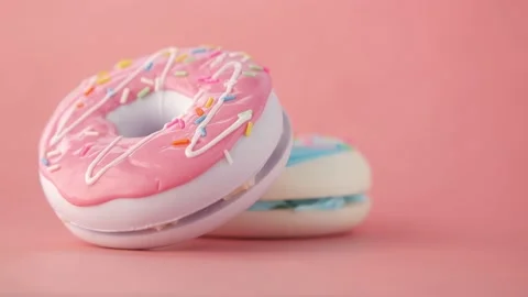 Stack of chocolate donuts on a pink background Stock Footage 164150404