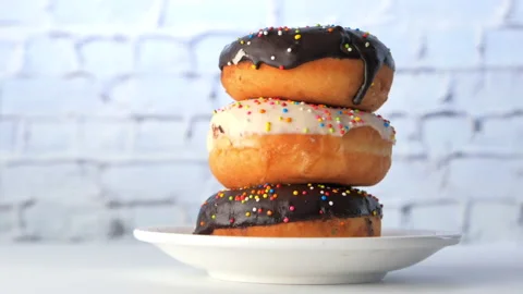 Stack of chocolate donuts on plate with copy space Stock Footage 140800445