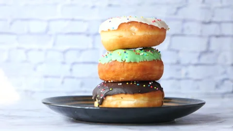 Stack of chocolate donuts on plate with copy space Stock Footage 147862189
