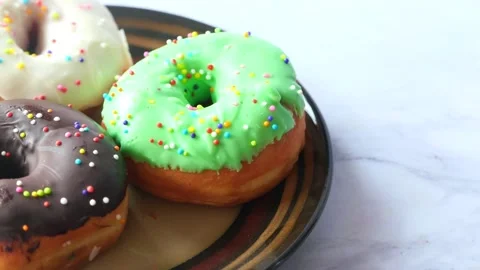 Stack of chocolate donuts on plate with copy space Stock Footage 148290005