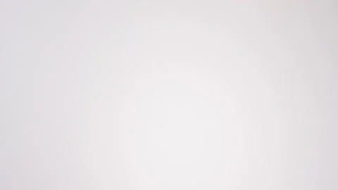 Stack of chocolate iced cake donuts raining on white slow motion macro food Stock Footage 337909935