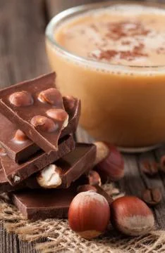 Stack of chocolate with nuts beans of coffe and star anise Stock Photos