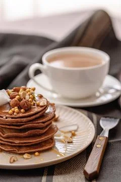 Stack of chocolate pancakes with maple syrup, honey and cup of coffee, nice s Stock Photos