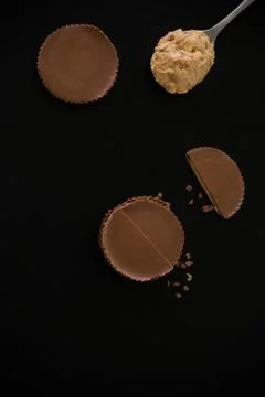 Stack of chocolate peanut butter cup on black background. Stock Photos