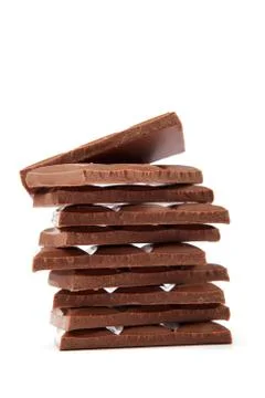 Stack of chocolate pieces on a white background. Stock Photos