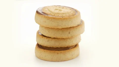 Stack of Chocolate round biscuits or cookies rotating Stock-Footage 129909791