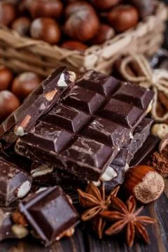 Stack of chocolate slices with mint leaf on a wooden table.Assortment of fine Stock Photos