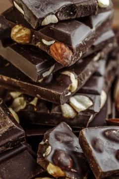 Stack of chocolate slices with mint leaf on a wooden table.Assortment of fine 스톡 사진