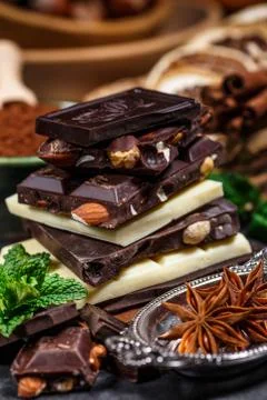 Stack of chocolate slices with mint leaf on a wooden table.Assortment of fine Stock Photos