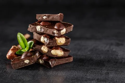 Stack of chocolate slices with mint leaf.Hazelnut and almond milk and dark ch Foto stock