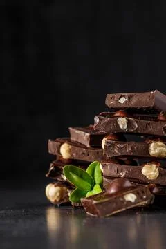 Stack of chocolate slices with mint leaf.Hazelnut and almond milk and dark ch Stock Photos