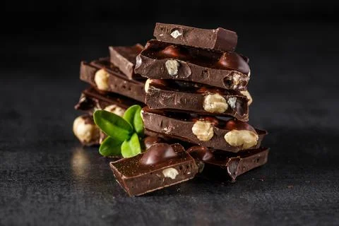 Stack of chocolate slices with mint leaf.Hazelnut and almond milk and dark ch Stock Photos