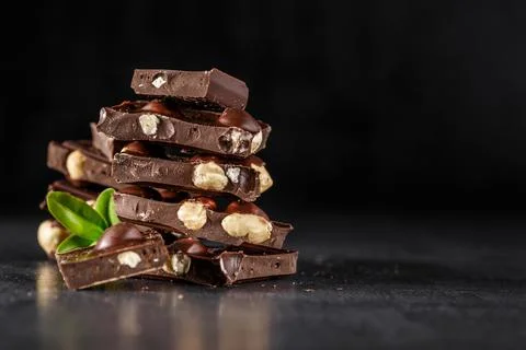 Stack of chocolate slices with mint leaf.Hazelnut and almond milk and dark ch 스톡 사진