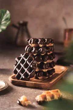 Stack of chocolate wafers on table on brown background Fotos de archivo