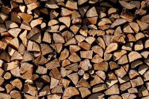 Stack of chopped firewood arranged in geometric pattern Stock Photos