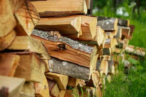 Stack of chopped firewood. Eco-friendly bio fuel. Woodpile near village house Stock-Fotos