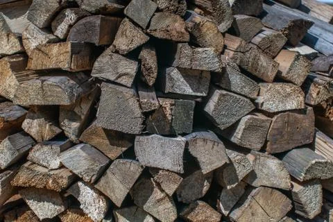 A stack of chopped firewood lies in the yard Stock Photos