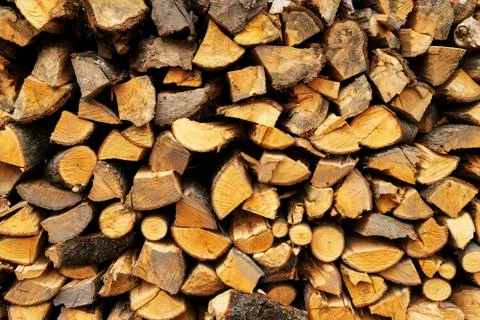 A stack of chopped firewood lies in the yard Stock Photos