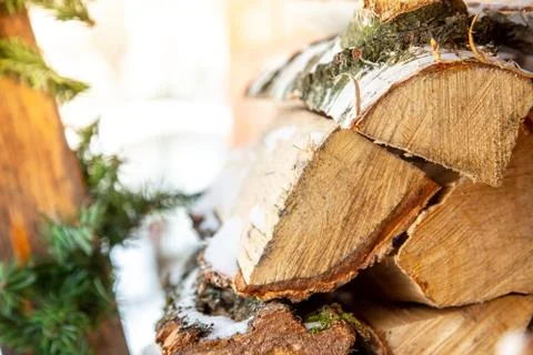 Stack of chopped pile firewood in snow Preparation of firewood for the winter Stock Photos