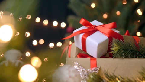 Stack of christmas gift boxes, fir tree and decorations in bokeh lights Stock Footage 141894878
