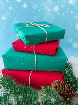 Stack of Christmas gifts with evergreen tree on snow. Winter holidays background Stock Photos
