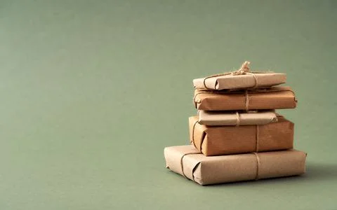 A stack of Christmas presents wrapped in ecological recycled paper with copy  Stock Photos