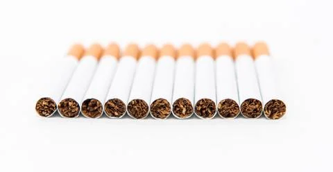 Stack of cigarette on the white background with partial focus. Stock Photos