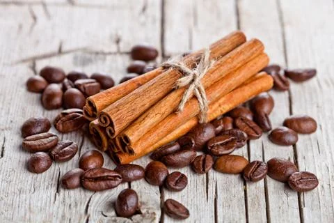 Stack of cinnamon sticks and coffee beans Stock Photos
