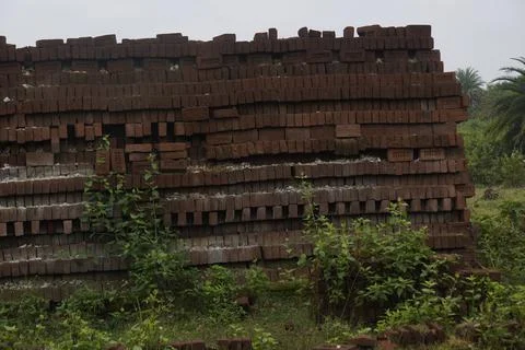 Stack of clay bricks arranged neatly at a construction site, Stock Photos