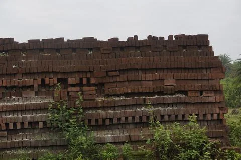 Stack of clay bricks arranged neatly at a construction site, Stock Photos