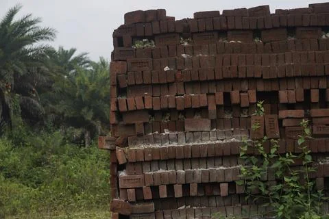 Stack of clay bricks arranged neatly at a construction site, Stock Photos