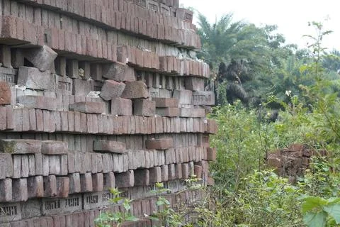 Stack of clay bricks arranged neatly at a construction site, Фото