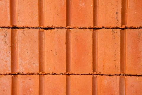 Stack of clay bricks building a wall Stock Photos