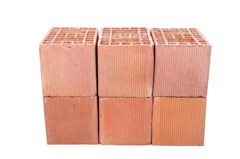 Stack of clay bricks isolated on white Foto stock