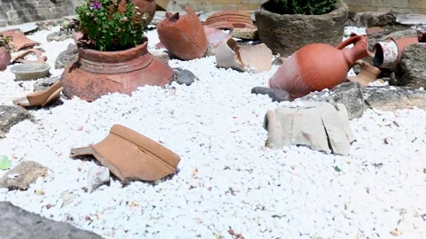 A stack of clay pots resting on a pile of rocks, great for home decor or na.. Stock Footage 342162498