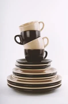 Stack of clean dishes in brown and beige Stock Photos
