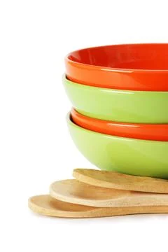 Stack of clean empty plates and wooden spoons  isolated on white background Stock Photos