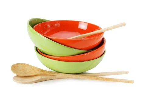 Stack of clean empty plates and wooden spoons  isolated on white background Stock Photos