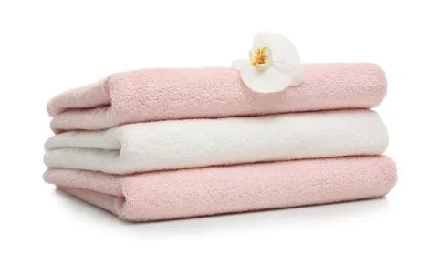 Stack of clean folded towels with flower on white background 스톡 사진