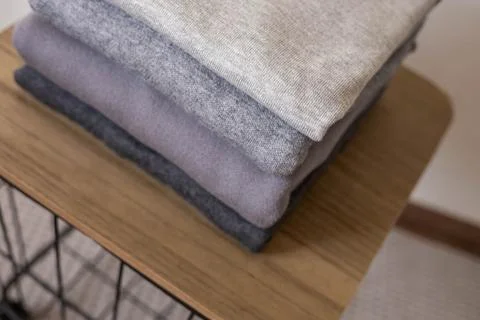 A stack of clean, freshly washed, gray, neatly folded women's clothing on a Stock Photos