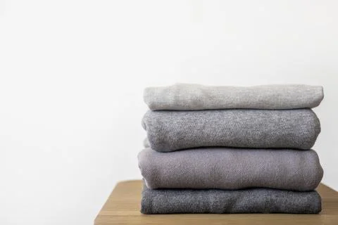 A stack of clean, freshly washed, gray, neatly folded women's clothing on a Stock Photos